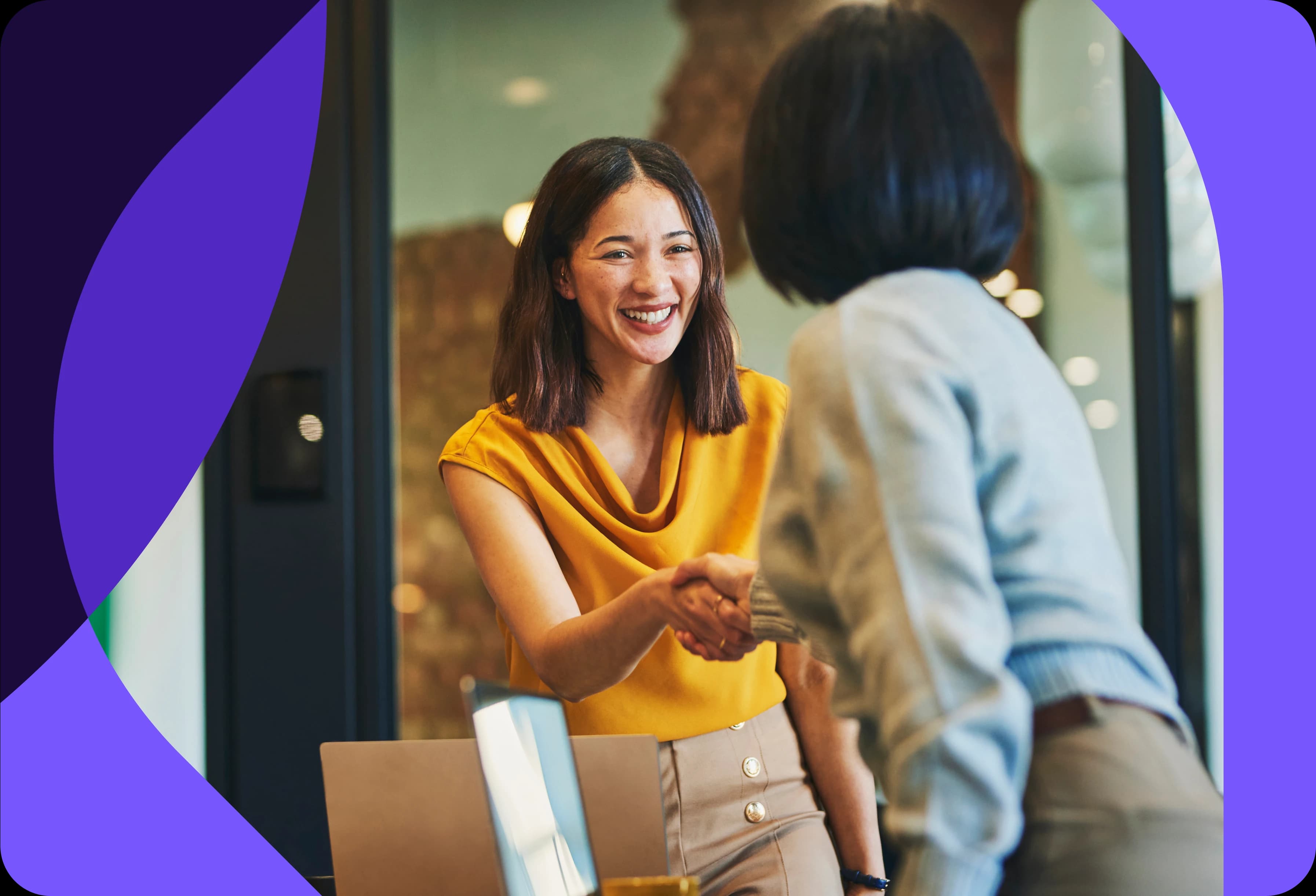 lady shaking another lady's hand