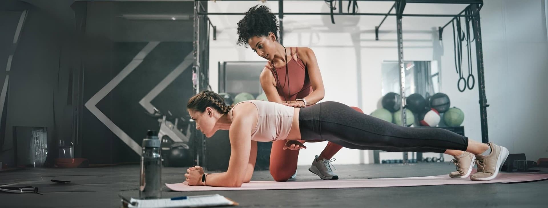 Gym trainer training woman